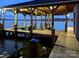 Covered boathouse with spacious dock at 8058 Edgewater Dr, Norwood, NC 28128