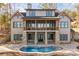 Lakefront home with stone accents, large windows, and a pool at 8058 Edgewater Dr, Norwood, NC 28128