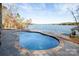 Freeform pool with stone coping overlooking lake at 8058 Edgewater Dr, Norwood, NC 28128