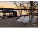 Private pool and boathouse with gorgeous sunset view over the lake at 8058 Edgewater Dr, Norwood, NC 28128