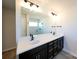 Elegant bathroom with double vanity, dark cabinets, and large mirror at 2033 White Cypress Ct # Kh06, Charlotte, NC 28216