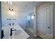 Modern bathroom with double vanity, quartz countertop and a glass shower at 2033 White Cypress Ct # Kh06, Charlotte, NC 28216