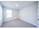 Well-lit bedroom with neutral walls and carpet at 2033 White Cypress Ct # Kh06, Charlotte, NC 28216