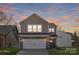 Two-story house with stone and shingle accents, two-car garage, and landscaping at 2033 White Cypress Ct # Kh06, Charlotte, NC 28216