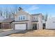 Two-story house with stone and shingle accents, two-car garage, and landscaping at 2033 White Cypress Ct # Kh06, Charlotte, NC 28216