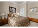 Neutral bedroom features carpet, a paisley bedspread, and a window with natural light, creating a serene atmosphere at 3006 Cricket Ln, Lancaster, SC 29720