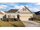 Charming single-Gathering home with manicured lawn and attached two-car garage in a suburban neighborhood at 3006 Cricket Ln, Lancaster, SC 29720