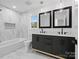 Double vanity bathroom with marble tile and modern fixtures at 3417 Chilham Pl, Charlotte, NC 28226