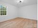 Bright bedroom with hardwood floors and large window at 3417 Chilham Pl, Charlotte, NC 28226