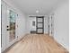 Bright hallway with sliding barn door and hardwood floors at 3417 Chilham Pl, Charlotte, NC 28226