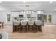 Bright kitchen with white cabinets, marble island, and French doors leading outside at 3417 Chilham Pl, Charlotte, NC 28226