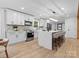 Modern kitchen with white cabinets, a large marble island, and stainless steel appliances at 3417 Chilham Pl, Charlotte, NC 28226