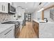 Open concept kitchen with white and wood cabinets and a marble island at 3417 Chilham Pl, Charlotte, NC 28226