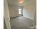 Bright bedroom with carpeted floor and window at 401 Imperial Way # 25, Albemarle, NC 28001