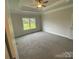 Bedroom with gray carpet, ceiling fan and large window at 401 Imperial Way # 25, Albemarle, NC 28001