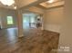 Open concept dining room with wood-look floors and views into the kitchen at 401 Imperial Way # 25, Albemarle, NC 28001