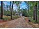 New construction of a two-story home with gray siding on a large wooded lot surrounded by tall trees at 4615 Yellow Poplar Ln, Concord, NC 28025