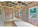 Framed interior showcasing exposed beams, insulation, and natural light through bright windows at 4615 Yellow Poplar Ln, Concord, NC 28025
