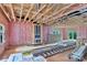 Framed living room displaying rough pink insulation, wood beam ceilings, and a view to the backyard at 4615 Yellow Poplar Ln, Concord, NC 28025