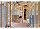 Unfinished room interior with exposed stud framing, insulation, and plywood subfloor at 4615 Yellow Poplar Ln, Concord, NC 28025