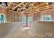 Unfinished room interior with exposed beams, insulation, plywood subfloor and drywall at 4615 Yellow Poplar Ln, Concord, NC 28025