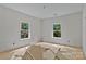 Spacious, unfinished bedroom featuring two bright windows providing natural light and scenic views at 4641 Yellow Poplar Ln, Concord, NC 28025