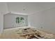 Incomplete bedroom with natural light, drywall, and flooring materials at 4641 Yellow Poplar Ln, Concord, NC 28025