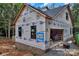 New home's exterior with wrap, dark trim windows, and a garage in a beautiful neighborhood at 4641 Yellow Poplar Ln, Concord, NC 28025