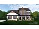 Charming two-story home with a covered porch and beautifully landscaped front yard for enhanced curb appeal at 4641 Yellow Poplar Ln, Concord, NC 28025