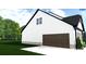 Garage side view of a two-story home with white siding and a well-manicured lawn at 4641 Yellow Poplar Rd, Concord, NC 28025