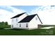 Angled rear view of a two-story home with white siding and a side entry garage at 4641 Yellow Poplar Rd, Concord, NC 28025