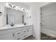 Bathroom with double vanity, dark countertop and a separate tub at 1194 Lost Cove Rd, Indian Land, SC 29707