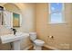 Stylish powder room with patterned wallpaper and a pedestal sink at 1194 Lost Cove Rd, Indian Land, SC 29707