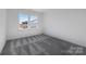 Bright bedroom with grey carpet and two large windows at 1194 Lost Cove Rd, Indian Land, SC 29707