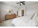 Well-lit bedroom with dresser and a comfortable bed at 1194 Lost Cove Rd, Indian Land, SC 29707