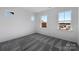 Spacious bedroom with gray carpet and multiple windows at 1194 Lost Cove Rd, Indian Land, SC 29707