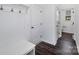 Clean hallway featuring white bench, dark floors, and doors at 1194 Lost Cove Rd, Indian Land, SC 29707