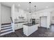 Modern kitchen with white cabinets, dark countertops, and island at 1194 Lost Cove Rd, Indian Land, SC 29707