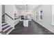 Open concept kitchen with island, dark floors, and white cabinets at 1194 Lost Cove Rd, Indian Land, SC 29707