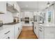 White kitchen with stainless steel appliances and an island with seating at 1194 Lost Cove Rd, Indian Land, SC 29707