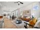 Bright and airy living room with a leather couch and large windows at 1194 Lost Cove Rd, Indian Land, SC 29707