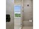 Large shower with built-in seat and window views at 1194 Lost Cove Rd, Indian Land, SC 29707