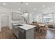 Modern kitchen with island, stainless steel appliances, and gray cabinets at 1198 Lost Cove Rd, Indian Land, SC 29707