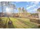 Expansive backyard featuring mature trees, a fire pit, and a back deck at 159 Rubys Way # 35, Oakboro, NC 28129