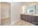 Spacious bathroom with double vanity, large mirror, and view into a closet and separate toilet at 159 Rubys Way # 35, Oakboro, NC 28129