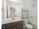 A full bathroom with a shower-tub combo and a wooden vanity at 159 Rubys Way # 35, Oakboro, NC 28129