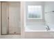 Well-appointed bathroom showcasing a bathtub, a separate shower, and a window at 159 Rubys Way # 35, Oakboro, NC 28129