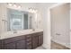 Well-lit bathroom featuring a double vanity, large mirror, and modern fixtures at 159 Rubys Way # 35, Oakboro, NC 28129