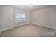 A carpeted bedroom with a window that allows for natural light to enter the room at 159 Rubys Way # 35, Oakboro, NC 28129