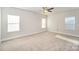 Spacious bedroom featuring large windows, neutral carpet, and a ceiling fan at 159 Rubys Way # 35, Oakboro, NC 28129